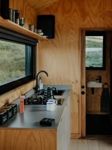 a kitchen in a tiny house with a counter top at Hoku in Llangollen +13 photos