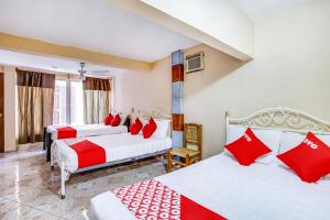 Ένα ή περισσότερα κρεβάτια σε δωμάτιο στο OYO Hotel Margarita