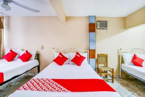 Ένα ή περισσότερα κρεβάτια σε δωμάτιο στο OYO Hotel Margarita