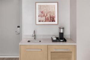 a kitchen with a sink and a coffee maker at Hilton Garden Inn New York Manhattan Midtown East in New York +47 photos