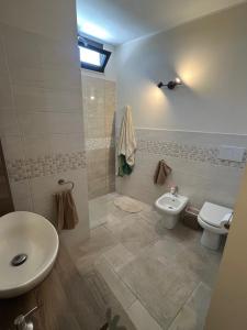 a bathroom with a toilet and a sink at Dimora dei Climiti in Floridia +12 photos