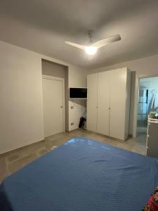 an empty room with a large blue bed in it at Dimora dei Climiti in Floridia