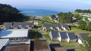 an aerial view of a village with houses and the ocean at VVF La côte d'Emeraude Saint-Cast-le-Guildo in Saint-Cast-le-Guildo