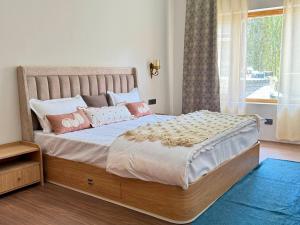 une chambre avec un grand lit avec des oreillers roses dans l'établissement TSAO by the orchard-Boutique Stay, à Leh