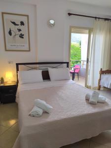 a bedroom with a large bed with towels on it at Valbona Apartments in Vlorë