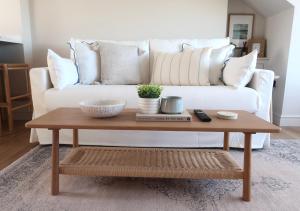 a coffee table in front of a white couch at Apartments in the centre of Donaghadee in Donaghadee