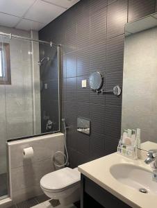 a bathroom with a shower and a toilet and a sink at Tripper Inn Dammam in Dammam