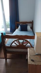 a bed with a blue pillow on it in a room at Nada Rooms in Budva