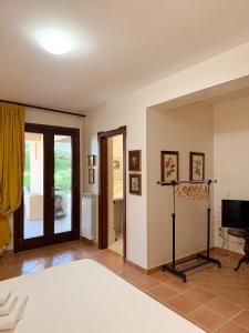 a room with a bed and a television in it at Villa Bellavista Luxury Suites in LʼAquila