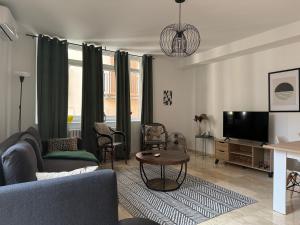 a living room with a couch and a tv at 18 Torres Santa Cruz in Zaragoza