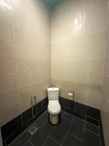 a bathroom with a white toilet in a stall at Xscape Tambun - Cabin in the Valley in Tambun