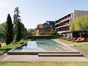 a swimming pool in front of a building at Vinha Boutique Hotel - The Leading Hotels of the World in Vila Nova de Gaia