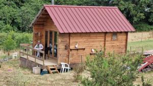 a small wooden house with a red roof at La casita in Villefranque +15 photos