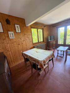 a dining room with a table and chairs in it at Choucas in Thollon