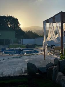 a patio with a tent and a swimming pool at Da Franco in Santa Luria