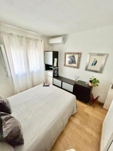 a bedroom with a large white bed in a room at Double room in apartment Marbella Center WOMEN ONLY in Marbella