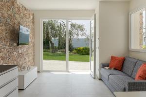 a living room with a couch and an open door at Villa Serena in Finale Ligure