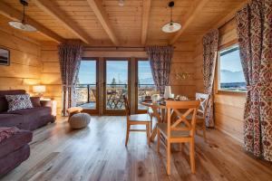 a living room with a table and a couch at Domki Tatra Loft in Ząb