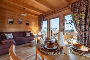a living room with a table and a couch at Domki Tatra Loft in Ząb +45 photos