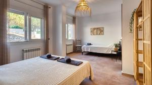 a bedroom with a bed in a room at Costacabana - Villa Ibiza in Lloret de Mar +15 photos