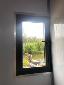 a bathroom window with a view of a river at Phan House in Ha Tien