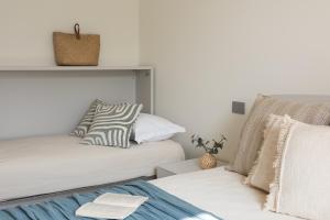 a bedroom with two beds and a pillow at Villa Serena in Finale Ligure