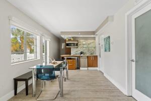 a dining room and kitchen with a table and chairs at Spacious APT on South Beach Roof Top Pool & Bar in Miami Beach