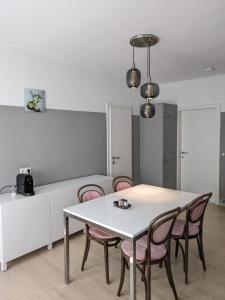 a dining room with a white table and chairs at Apartment in Schottwien +11 photos
