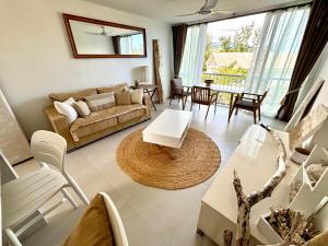 a living room with a couch and a table at T2 duplex- piscine- vue mer in Saint-Paul