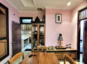 a dining room with a wooden table and chairs at Villa Yoni in Bali in Pesanggaran