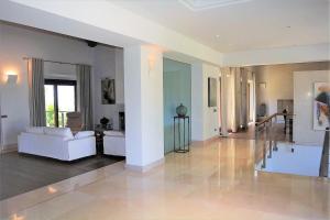 a living room with a white couch and a table at Andratx Villa: A Stylish Oasis of Relaxation, 1043 in Andratx +38 photos