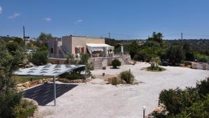 a house with a solar array in a yard at Villa Bella Vista - VIP by Salento Prime in Marina di Pescoluse +13 photos