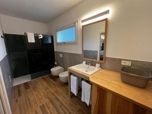 a bathroom with a sink and a toilet and a mirror at MyCircle Stintino in Stintino
