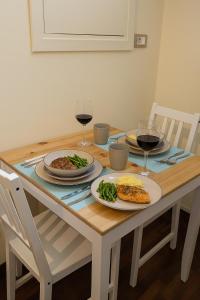 a wooden table with plates of food and wine glasses at Residenza la Sapienza in Viterbo