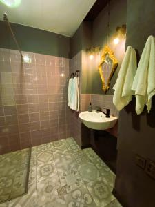 a bathroom with a sink and a shower at Wonderwood Borjomi Provencal in Borjomi