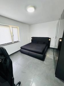 a bedroom with a black bed in a room at Luxury Apartment in Herne