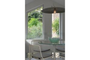 a dining room with a table and chairs and a window at Via dei Monti in Nesso