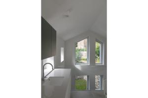 a kitchen with white counters and a window at Via dei Monti in Nesso