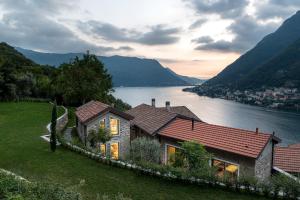 a house on a hill next to a body of water at Via dei Monti in Nesso