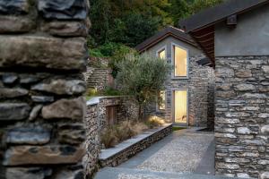 a stone house with a stone wall at Via dei Monti in Nesso +20 photos