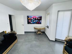 a living room with a couch and a chandelier at Luxury Apartment in Herne