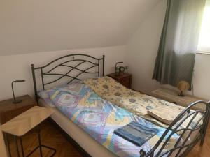 a bed with a quilt on it in a bedroom at Kuća Sokolovića in Zaječar
