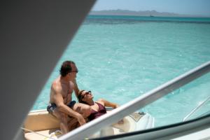 a man and woman sitting on a boat in the water at Hotel Sultan Bey Resort in Hurghada