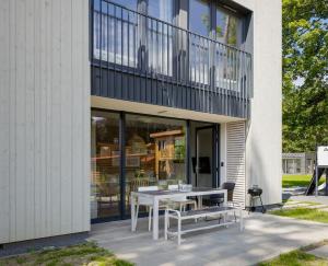 a white table and chairs on a patio at LoveSea apartments Rewal in Rewal