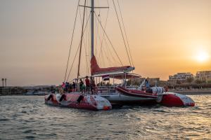 a boat in the water with people on it at Hotel Sultan Bey Resort in Hurghada