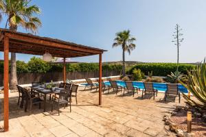 a patio with a table and chairs and a pool at Brisa Marina in Cala en Blanes