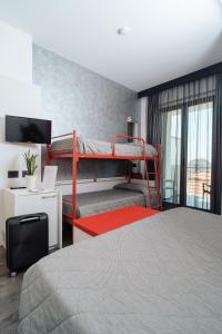 a bedroom with two bunk beds and a television at Eden Hotel in San Salvo +34 photos