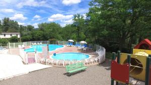 a large swimming pool with chairs and a slide at VVF Les Gorges de l'Allier in Lavoûte-Chilhac +17 photos