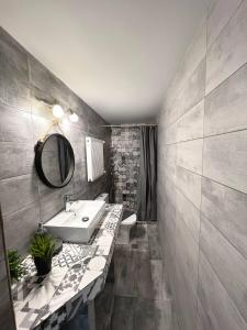 a bathroom with a sink and a toilet and a mirror at Artistic Escape in Vasilikí +21 photos