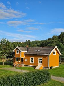 a house with an orange and white house at Storsand Gård in Trondheim